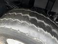 A close-up view of a worn tire from a 2013 International Workstar 7500 showing a rugged tread pattern and visible signs of wear and tear