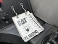 A Caterpillar TL1055C control panel featuring a key tag with various symbols and a touchscreen icon labeled TL1055C