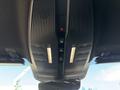 The interior ceiling console of a 2023 Fisker Ocean with buttons for lights and features in a sleek design
