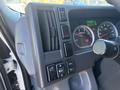 Dashboard controls of a 2022 Isuzu NQR featuring switches for ventilation lights and various functions along with gauges for speed and engine status
