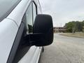 A close-up of the side mirror of a 2020 Ford Transit 250