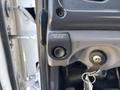 A close-up of the park brake release button on a 2014 Freightliner M2 106 with a key inserted in the ignition slot