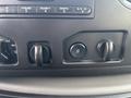 Controls and buttons on the dashboard of a 2013 Ford E-350 Super Duty including knobs for air flow and a traction control button