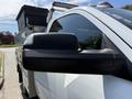 A close-up of the side mirror of a 2020 Ram 2500 truck with silver paint and a sturdy exterior design