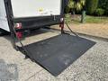 A 2008 Ford Econoline with a lowered loading ramp at the back ready for cargo loading