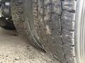 Close-up of a worn tire from a 2013 International Workstar 7500 showing deep treads and visible signs of usage and wear