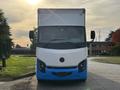 Front view of a 2022 Lion Lion6 electric delivery truck featuring a blue and white design with a distinct logo on the front