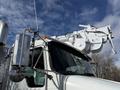 A 2008 Kenworth T370 with a white boom arm mounted on top and a polished exhaust stack on the side