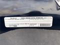 A sticker displaying vehicle emission control information for a 2015 RAM 1500 including details about the engine and regulations