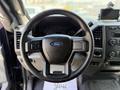 Steering wheel of a 2017 Ford F-550 with a Ford logo and control buttons on the left side