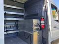 Interior of a 2024 Mercedes-Benz Sprinter 2500 showing metal storage boxes and shelving units