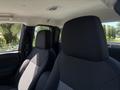 Interior view of a 2011 Chevrolet Colorado showing two front seats with fabric upholstery in black and gray