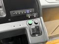 Close-up of a control panel featuring buttons labeled deploy and stow along with a gear selector with positions 1 2 3 D and R