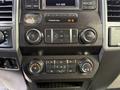 The dashboard of a 2017 Ford F-450 Super Duty featuring various dials and buttons for audio and climate control
