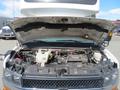 A 2020 Chevrolet Express with the hood raised, revealing the engine compartment showcasing various engine components and wiring
