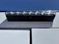 A close-up view of a light bar mounted on the back of a 2019 Ford F-150 featuring multiple circular lights arranged in a row