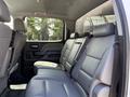 Interior view of the back seat of a 2020 Chevrolet Silverado featuring grey leather upholstery and seatbelts