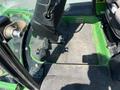 A 2016 John Deere 1585 Terrain Cut featuring the foot pedals and floor area inside the cabin