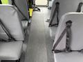Interior of a 2013 Chevrolet Express showing gray seats with seatbelts and a rubberized floor running through the middle