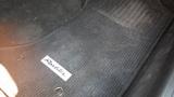 A close-up view of a floor mat with the label Roadster in a 2007 Mazda Miata