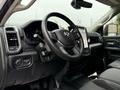 Interior view of a 2024 RAM 5500 showing the steering wheel dashboard and control panel with modern features and a touchscreen display
