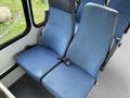 A pair of blue upholstered seats from a 2002 Ford Econoline van featuring a seatbelt on one side