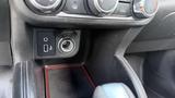 The interior console of a 2019 Nissan Kicks showing USB and auxiliary ports along with a textured surface and gear shifter