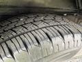 A close-up view of a tire from a 2013 Chevrolet Express showcasing its tread pattern and surface details
