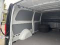 Interior of a 2021 Mercedes-Benz Metris van with gray paneling and two tires visible in the cargo area