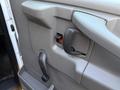 The interior door handle and locking mechanism of a 2015 GMC Savana with a pull handle and a lever for manual operation
