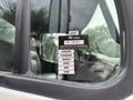 A 2006 Freightliner M2 106 truck with a certificate of approval sticker indicating months from January to June visible on the driver's side window