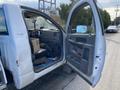 A 2009 Dodge Ram 5500 with an open door revealing the driver's seat and interior storage space, showing signs of wear and a box placed inside the cab