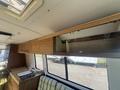 Interior of a 1976 GMC Motorhome featuring wooden cabinetry and a kitchenette with a sink and countertop