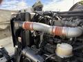 Close-up of the engine components of a 2008 Kenworth T370 showing various pipes and fittings with a focus on a large silver hose with red bands