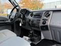Interior view of a 2012 Ford F-550 featuring a dashboard with controls, a steering wheel, and cup holders