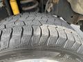 A close-up of a rugged tire tread on a 2014 Ford F-250 SD showcasing its deep grooves and strong grip pattern