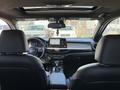 Interior view of a 2024 Kia Forte5 showcasing the dashboard featuring a touchscreen display and a modern steering wheel with a logo