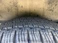 Close-up of a tire with deep treads from a 2025 Ford Transit T-350 showing wear patterns and texturing on the rubber surface