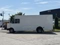 A white 2012 Ford Econoline cargo van is parked with a boxy shape and large rear storage area