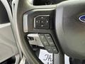 Close-up of the steering wheel of a 2020 Ford F-550 featuring control buttons for navigation and settings