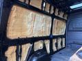 Interior of a 2022 Mercedes-Benz Sprinter van showing unpainted walls and insulation material applied to the surfaces