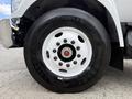 Close-up of a 2017 Ford F-750 tire showcasing a white rim with multiple lug nuts and the tire tread labeled Grenlander 11R22.5