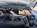 The engine bay of a 2010 Ford F-450 showing various mechanical components including the engine block hoses and coolant reservoir