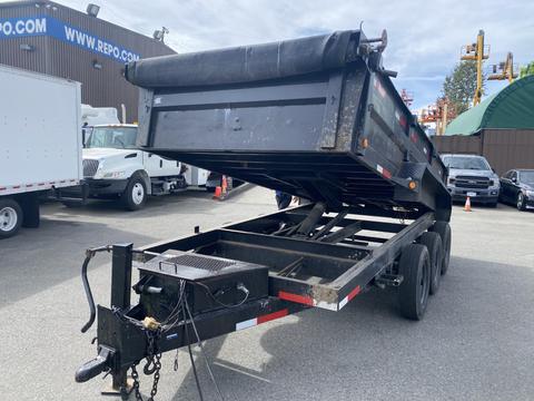 2014 PJ 16 Foot Dump Trailer with a raised bed displaying a black frame and dual axles visible in the foreground