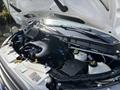 A 2016 Ford Transit 150 engine compartment showing various components including the air intake hose battery and fluid reservoirs