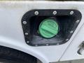 Green diesel fuel cap of a 2015 Ford F-550 with a labeled warning to tighten firmly