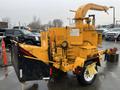 A yellow 1993 Bandit 200 wood chipper featuring a feed chute a trailer hitch and hydraulic controls or levers for operation