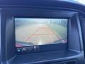 A rearview camera display showing a path with red guidelines for backing up a 2018 GMC Canyon