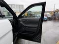 A 2019 Ford Explorer with the driver's side door open showcasing the interior features and controls