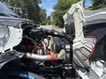 Close-up view of the engine compartment of a 2015 Ford F-750 showing the engine and various mechanical components with visible hoses and wiring